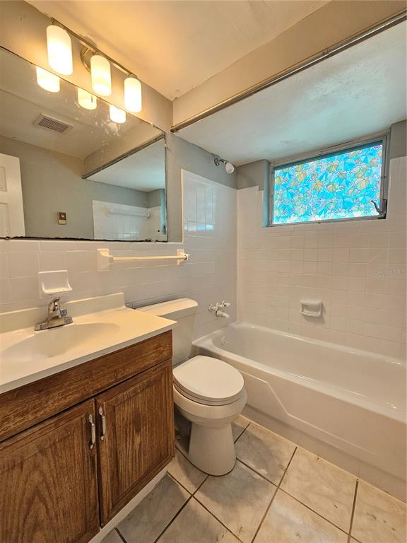 9210 Pegasus Avenue Port Richey, FL 34668 - Photo 12 of 19 a bathroom with a sink a toilet and a bathtub