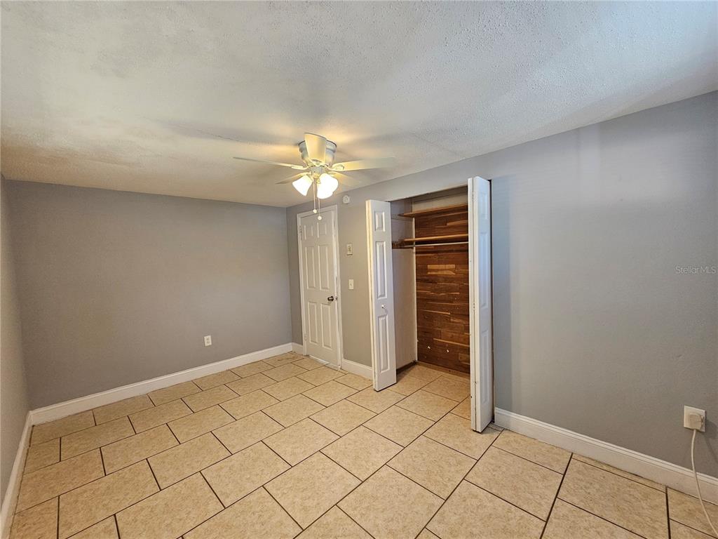 9210 Pegasus Avenue Port Richey, FL 34668 - Photo 13 of 19 a view of an empty room with wooden floor