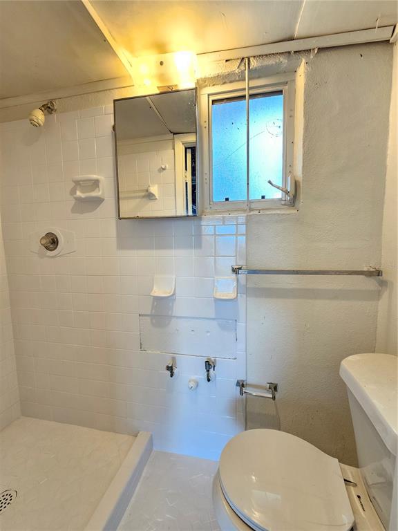 9210 Pegasus Avenue Port Richey, FL 34668 - Photo 14 of 19 a bathroom with a sink a toilet and shower