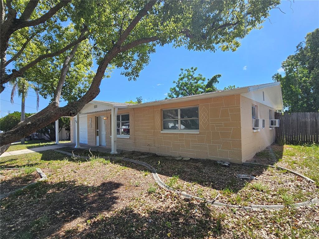 9210 Pegasus Avenue Port Richey, FL 34668 - Photo 3 of 19 a view of a house with a yard