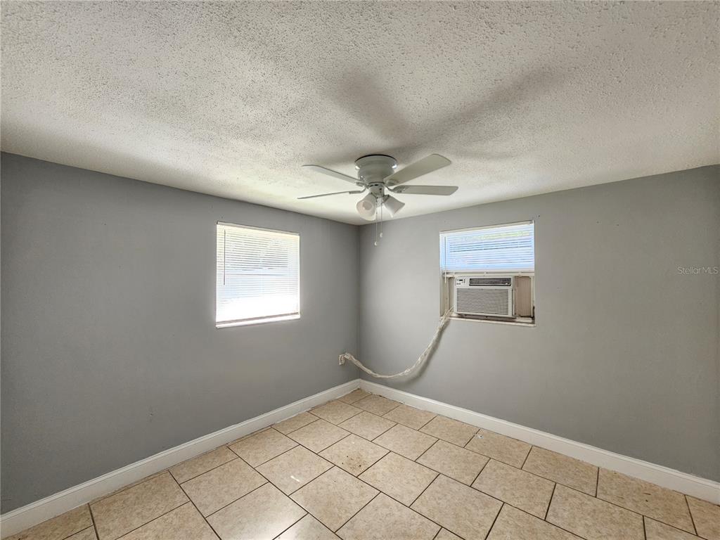 9210 Pegasus Avenue Port Richey, FL 34668 - Photo 10 of 19 an empty room with windows and fan