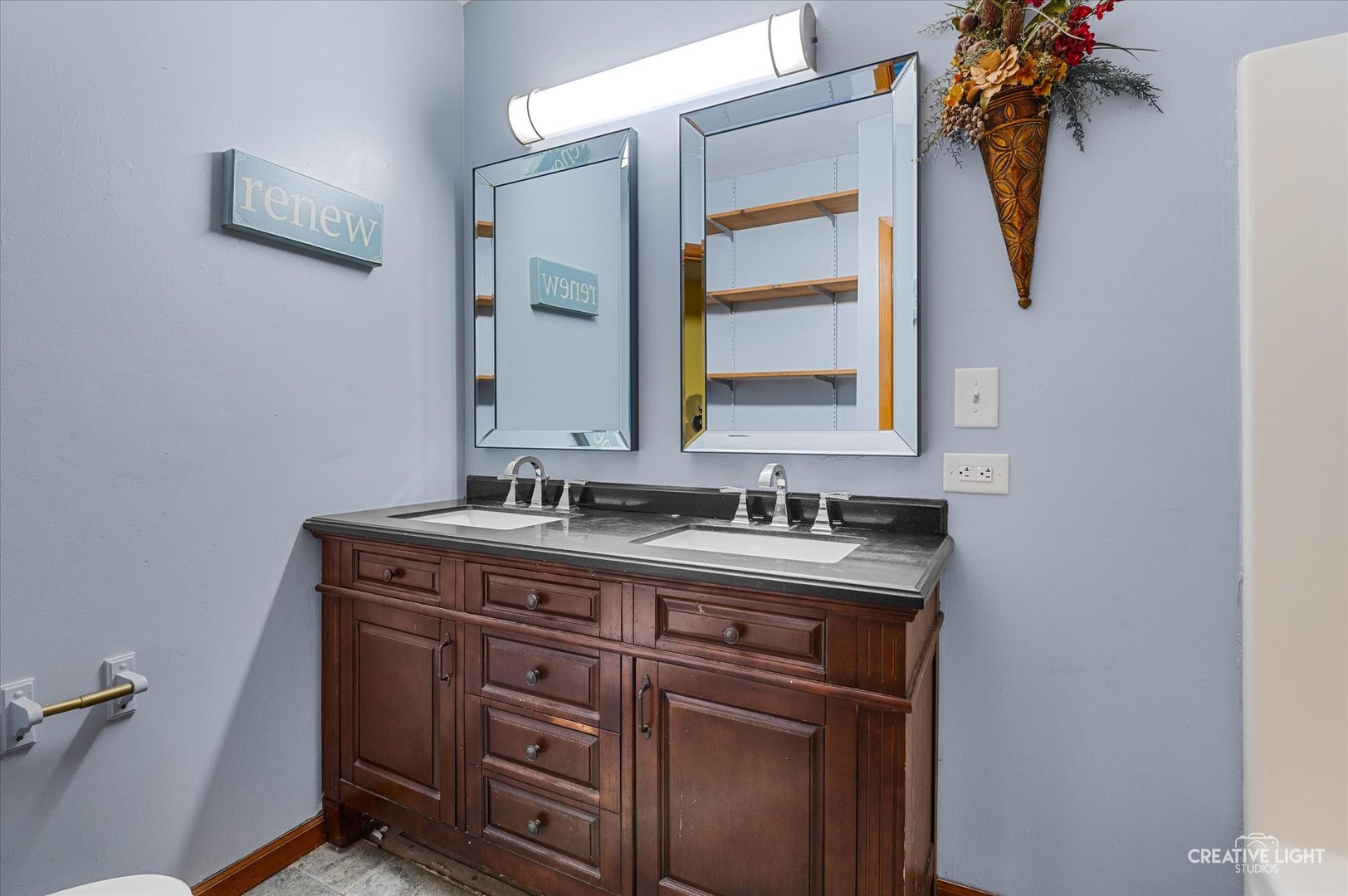 230 Comstock Street Joliet, IL 60436 - Photo 11 of 21 a bathroom with a granite countertop sink a mirror and vanity