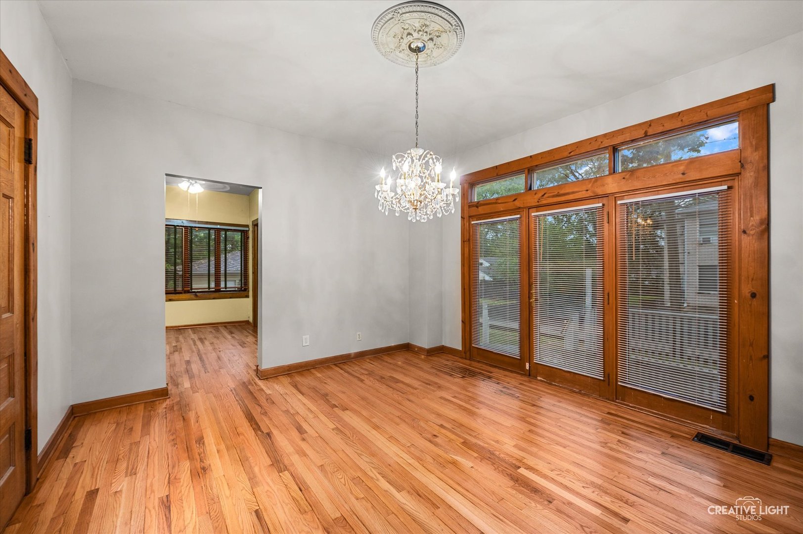 230 Comstock Street Joliet, IL 60436 - Photo 5 of 21 a view of empty room with wooden floor and fan