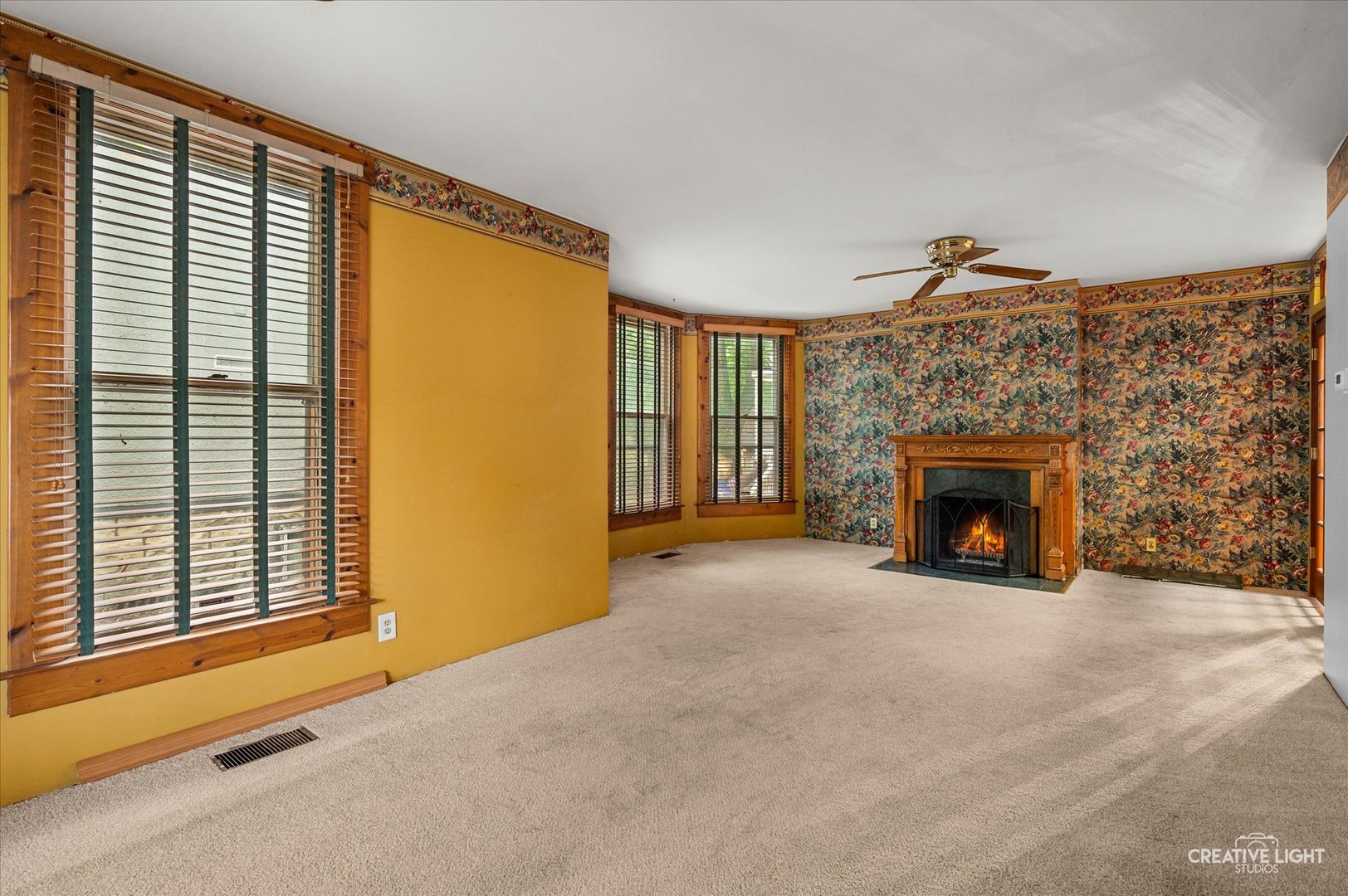 230 Comstock Street Joliet, IL 60436 - Photo 7 of 21 a view of an empty room with a fireplace and a window