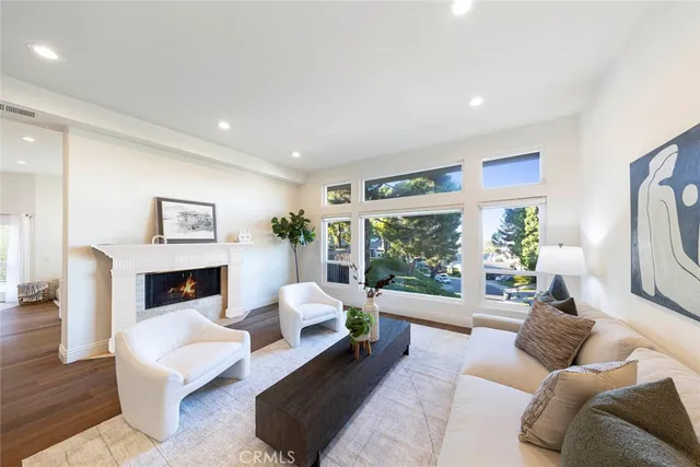 a living room with furniture large window and a fireplace