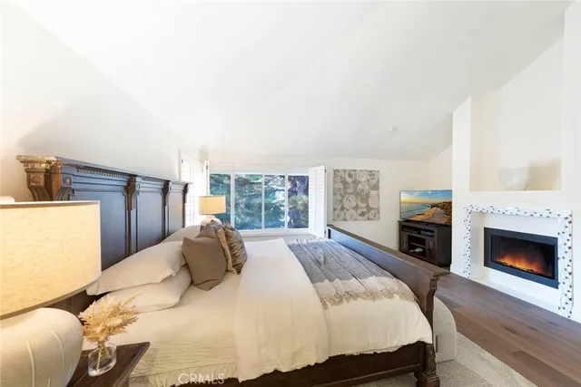 a bathroom with a bathtub shower sink mirror vanity and toilet