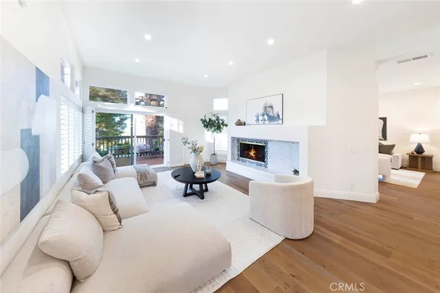 a large white kitchen with a large window and stainless steel appliances