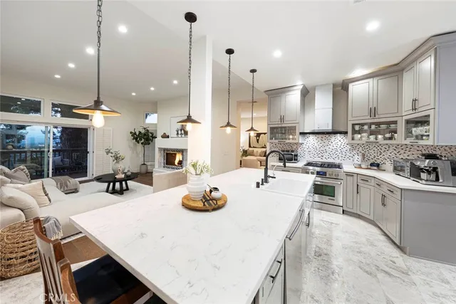 a living room with kitchen island furniture and a chandelier