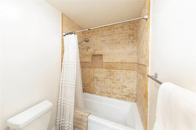 a bathroom with a shower and a toilet