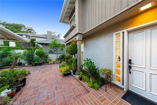a view of a balcony with chairs and wooden fence