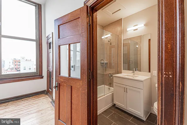a bathroom with a sink a toilet and a mirror