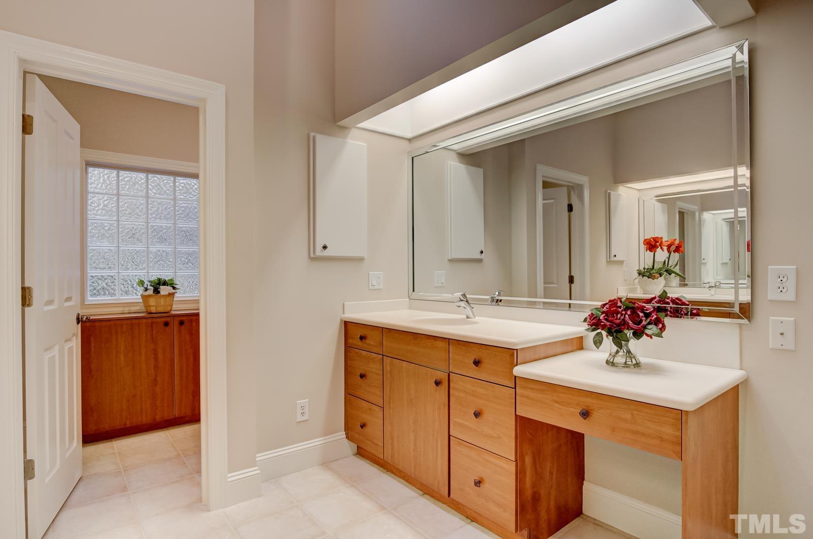 616 Bent Ridge Place Raleigh, NC 27615 - Photo 12 of 28 a bathroom with a sink and a mirror