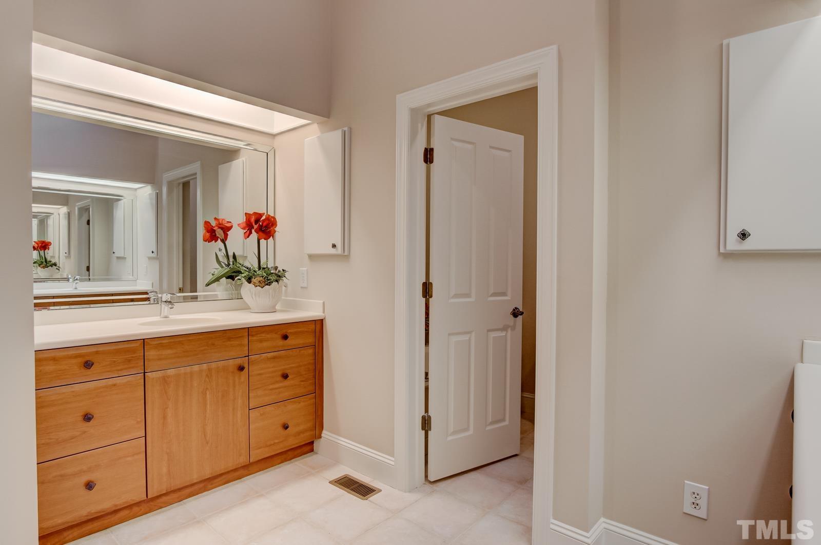 616 Bent Ridge Place Raleigh, NC 27615 - Photo 13 of 28 a bathroom with a sink and a mirror