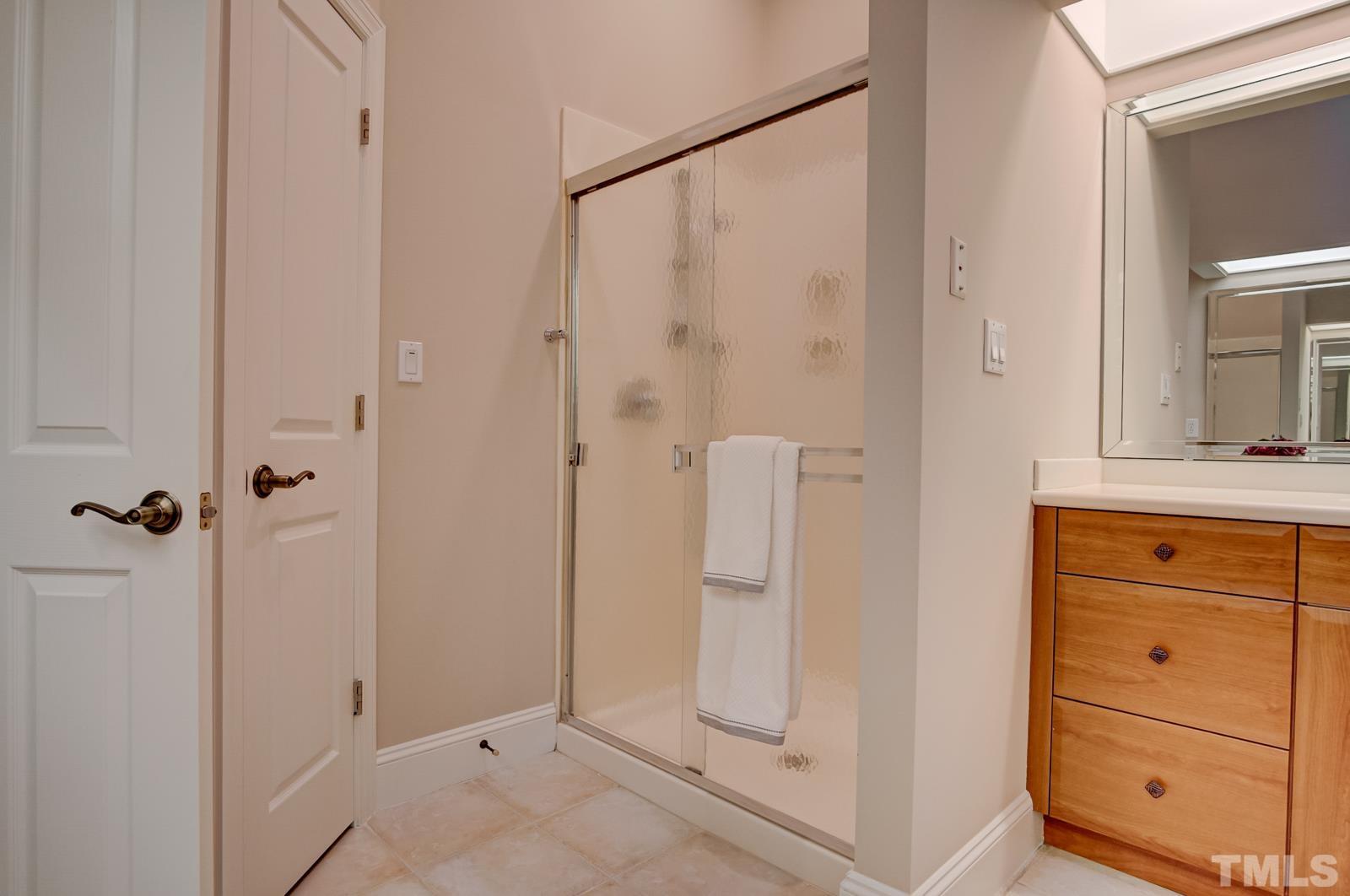 616 Bent Ridge Place Raleigh, NC 27615 - Photo 14 of 28 a bathroom with a shower and a sink