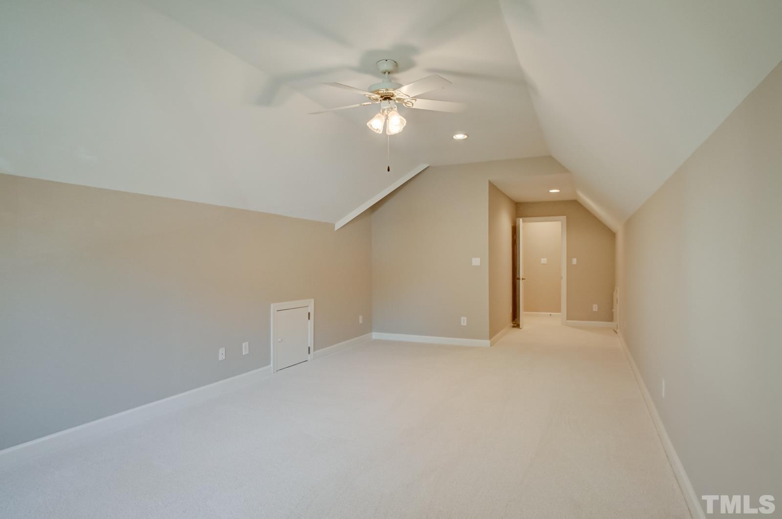 616 Bent Ridge Place Raleigh, NC 27615 - Photo 22 of 28 wooden floor in an empty room with a ceiling fan