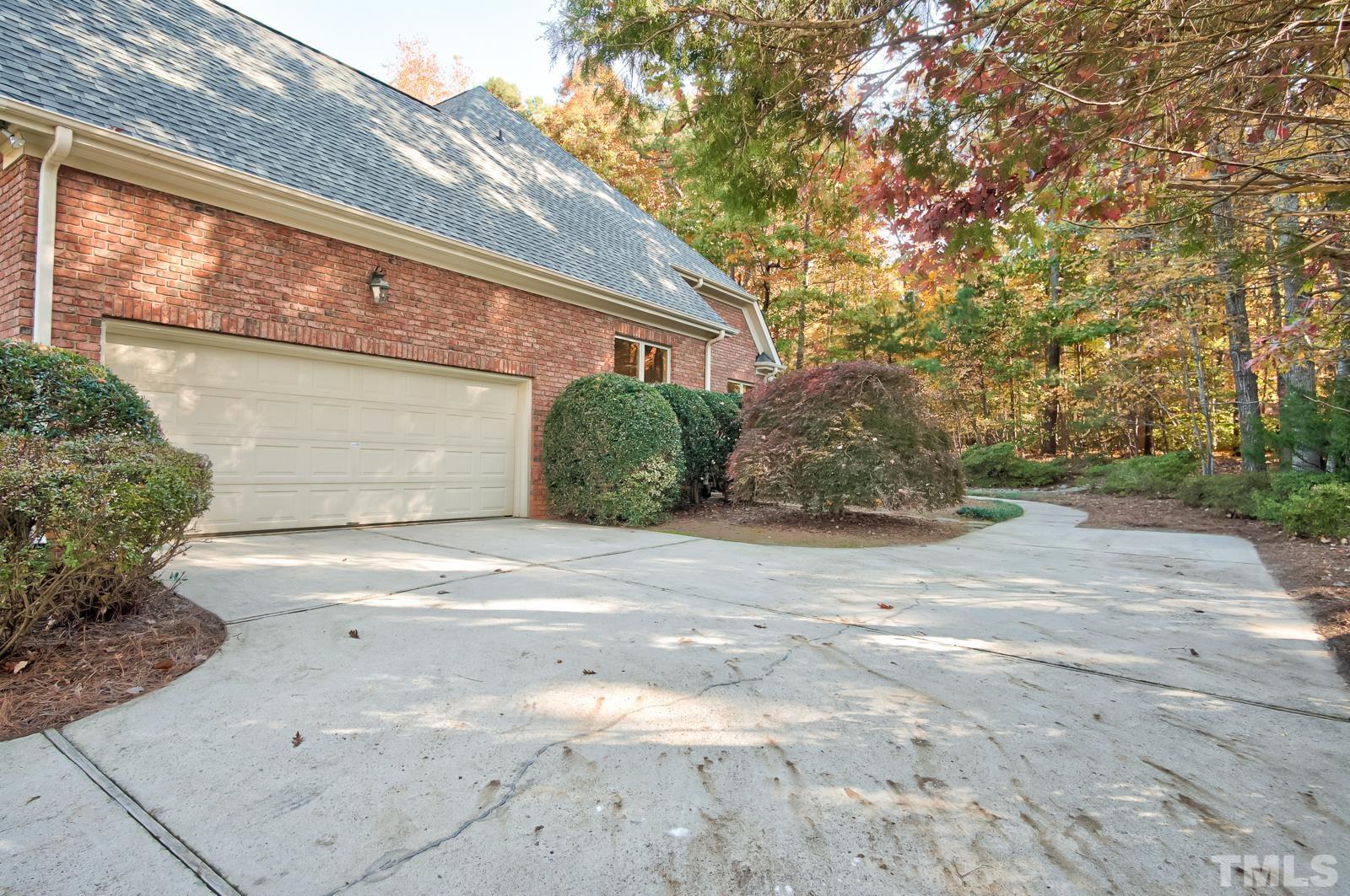 616 Bent Ridge Place Raleigh, NC 27615 - Photo 26 of 28 a front view of a house with a yard and garage