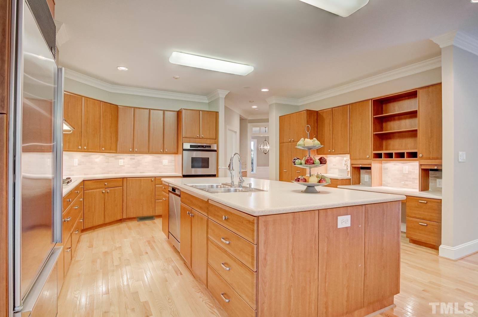 616 Bent Ridge Place Raleigh, NC 27615 - Photo 9 of 28 a large kitchen with stainless steel appliances a sink and cabinets