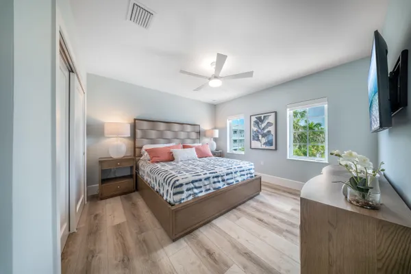 a bedroom with a large bed and a chandelier