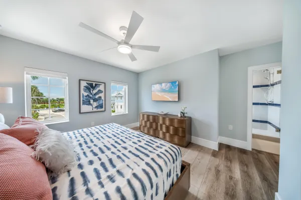 a bedroom with a large bed and a chandelier