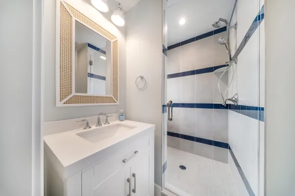 a bathroom with a sink a mirror and a shower