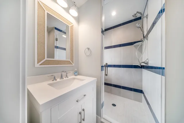 a bathroom with a sink a mirror and a shower