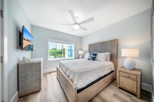 a bedroom with a bed and a flat screen tv