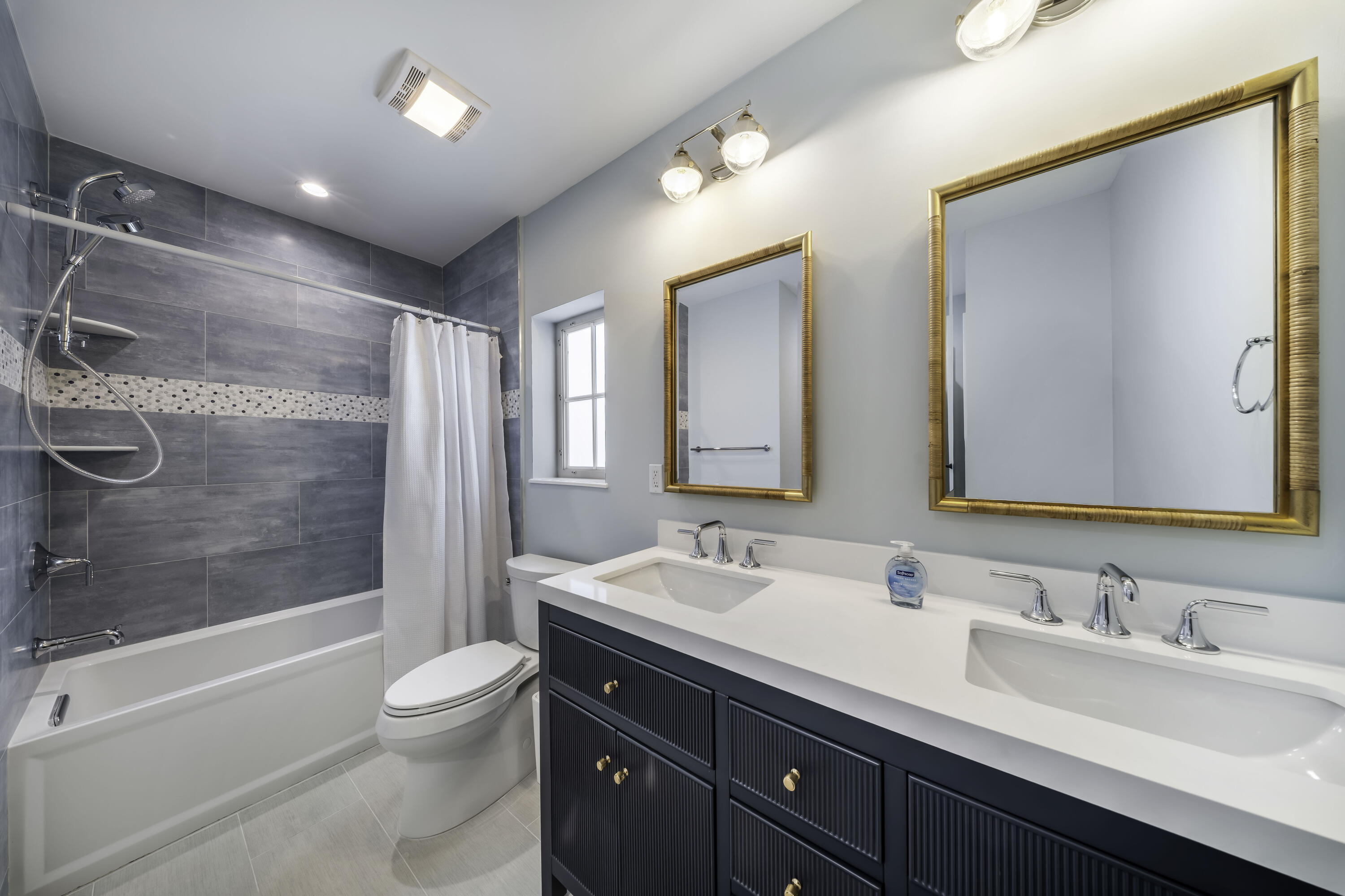 818 39th Street Marathon, FL 33050 - Photo 19 of 22 a bathroom with a double vanity sink toilet mirror and shower