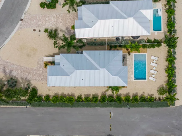 an aerial view of a house with a garden and trees