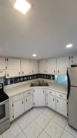 a kitchen with stainless steel appliances granite countertop a sink and cabinets