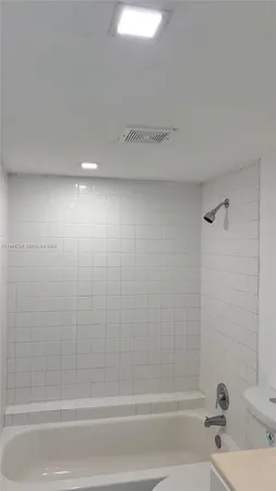 a bathroom with a sink a toilet and a bathtub