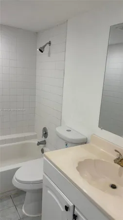 a bathroom with a toilet a sink and bathtub