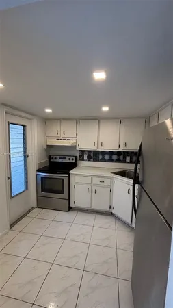a kitchen with stainless steel appliances a refrigerator sink and cabinets