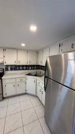 a kitchen with a cabinets and white appliances