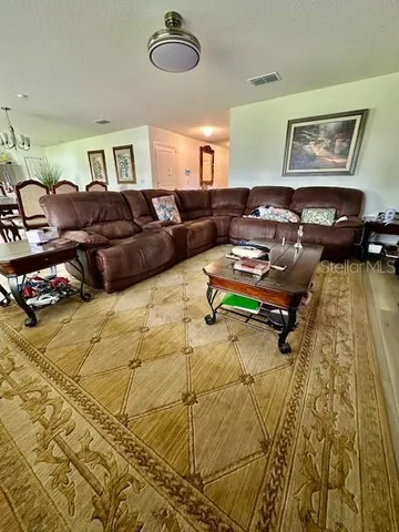 a living room with lots of furniture and a rug