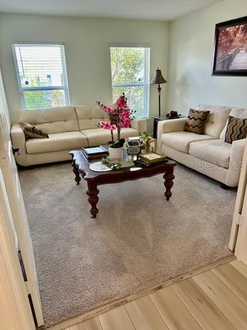 a living room with furniture and a window