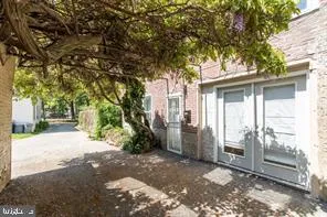 a view of a house with a tree beside it