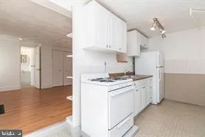 a kitchen with stainless steel appliances granite countertop a stove and a refrigerator
