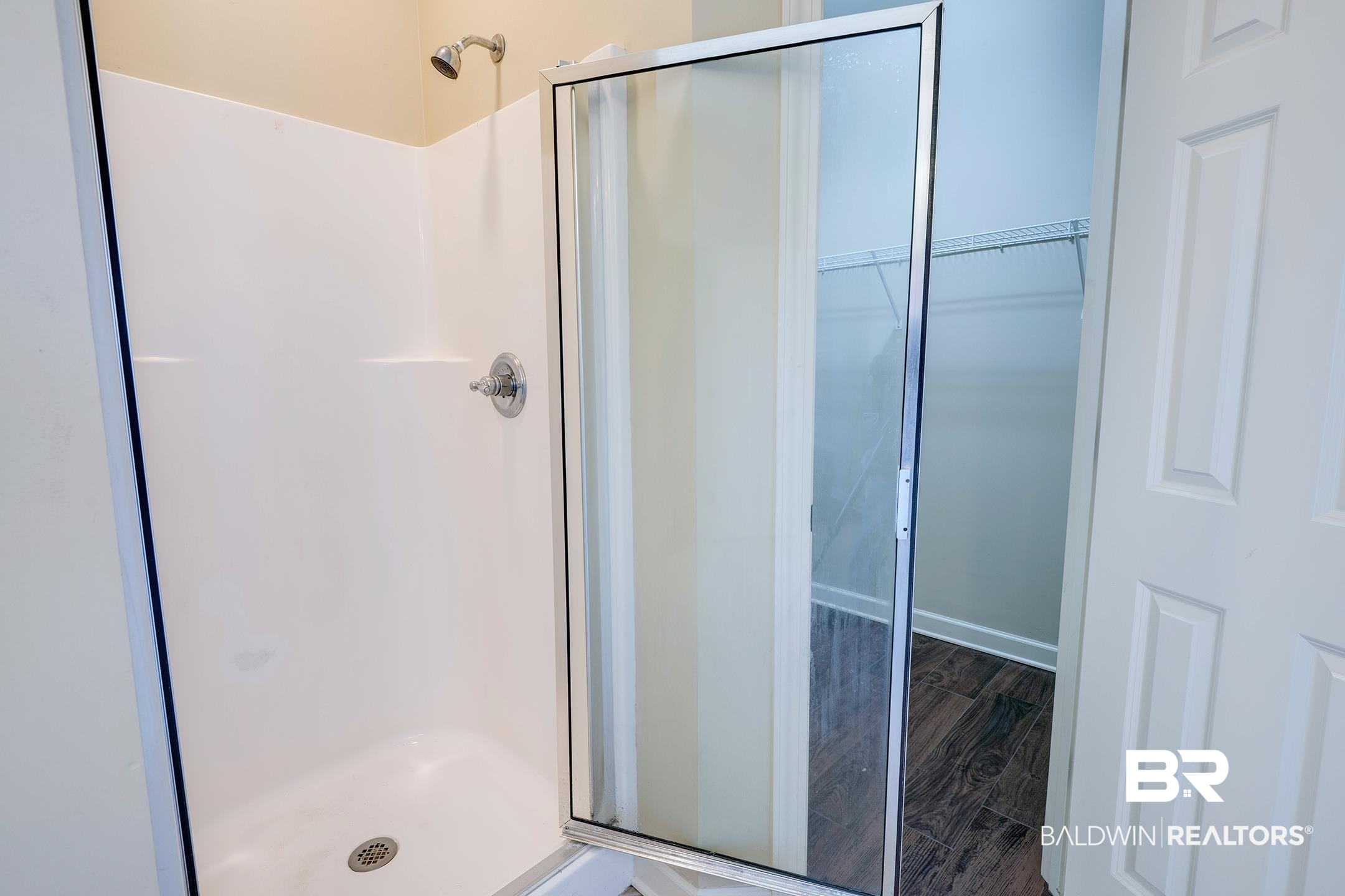 9421 Collier Loop Daphne, AL 36526 - Photo 27 of 31 Full bathroom with a stall shower, wood finished floors, and a spacious closet