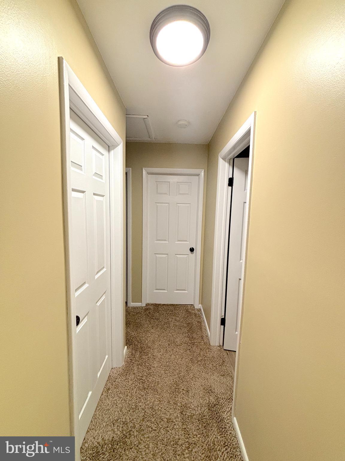26 Noble Road Sicklerville, NJ 08081 - Photo 23 of 33 a view of a hallway with wooden floor and a bathroom