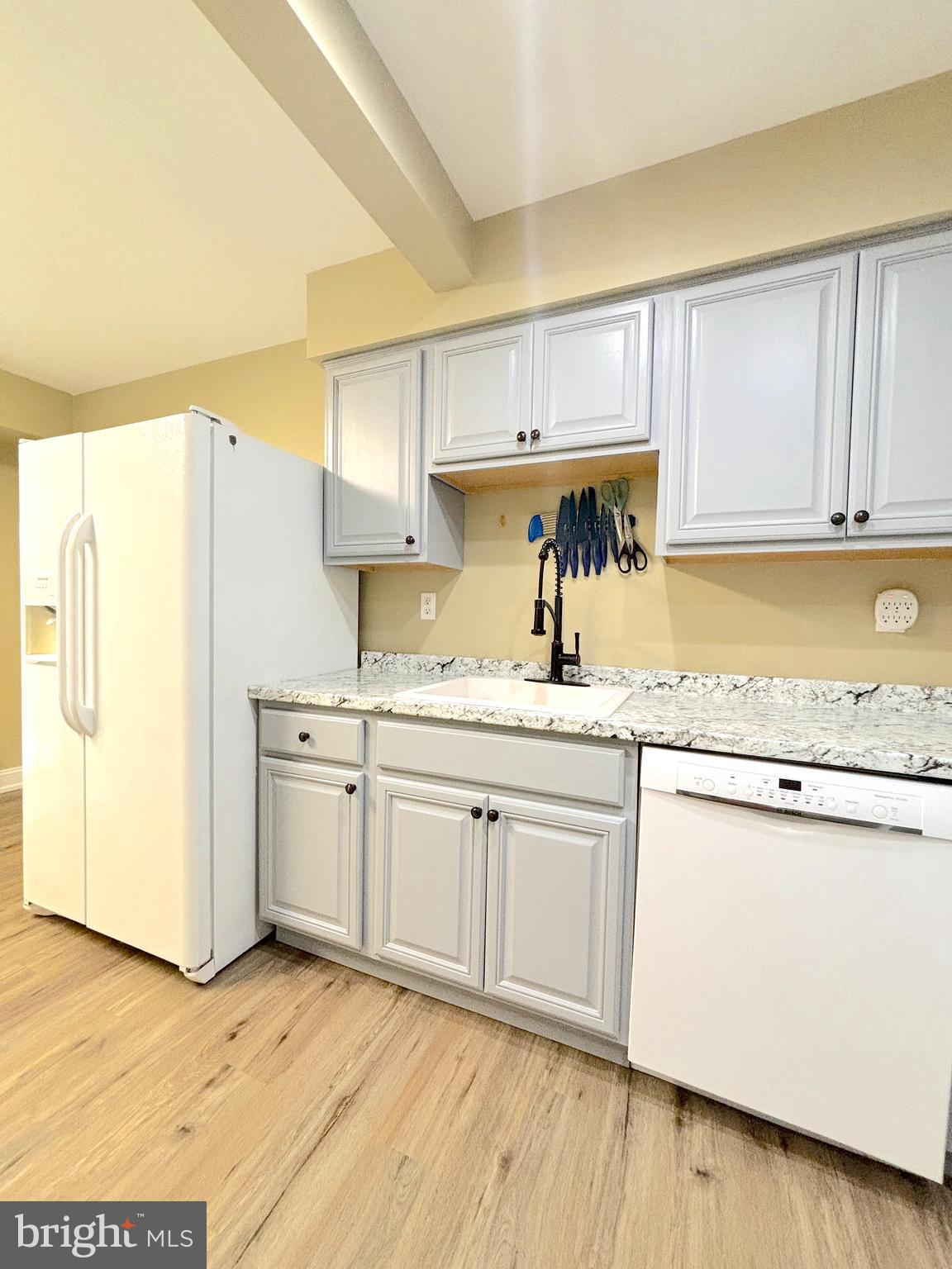 26 Noble Road Sicklerville, NJ 08081 - Photo 6 of 33 a kitchen with cabinets appliances wooden floor and a window