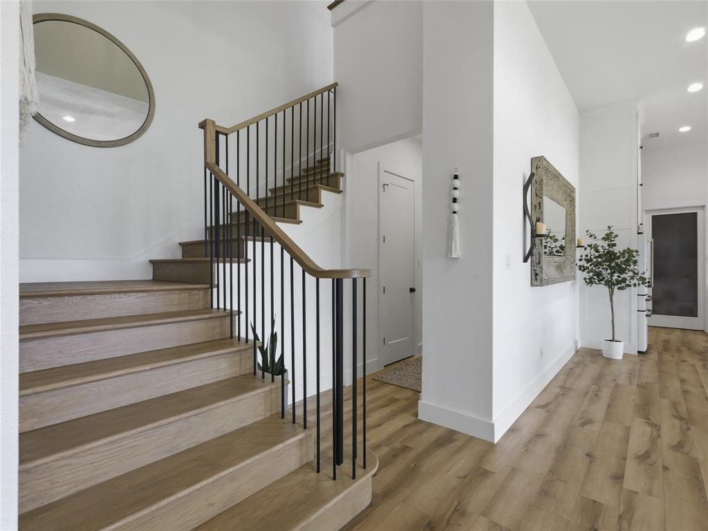 4211 Azalea Way Midlothian, TX 76065 - Photo 28 of 39 Hardwood staircase with black metal balusters and a wood-finish handrail