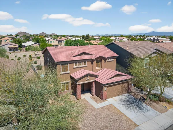 a aerial view of a house with a big yard and large trees