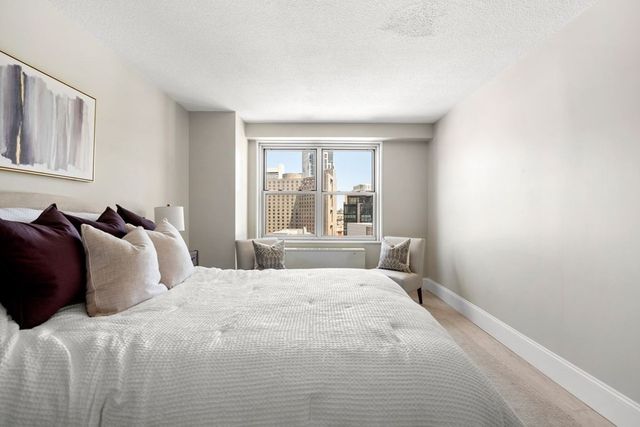 a bedroom with a large bed and a window with outer view