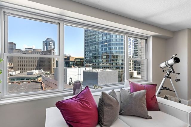 a living room with furniture and a floor to ceiling window