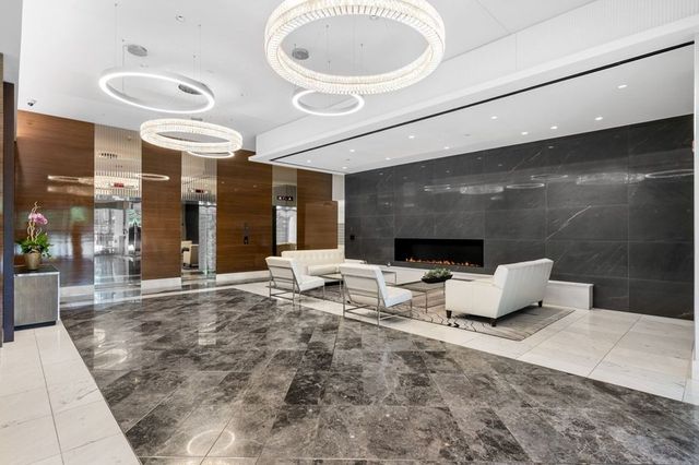 a lobby with furniture and a rug