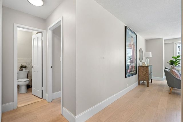 a view of a room with wooden floor and a bathroom