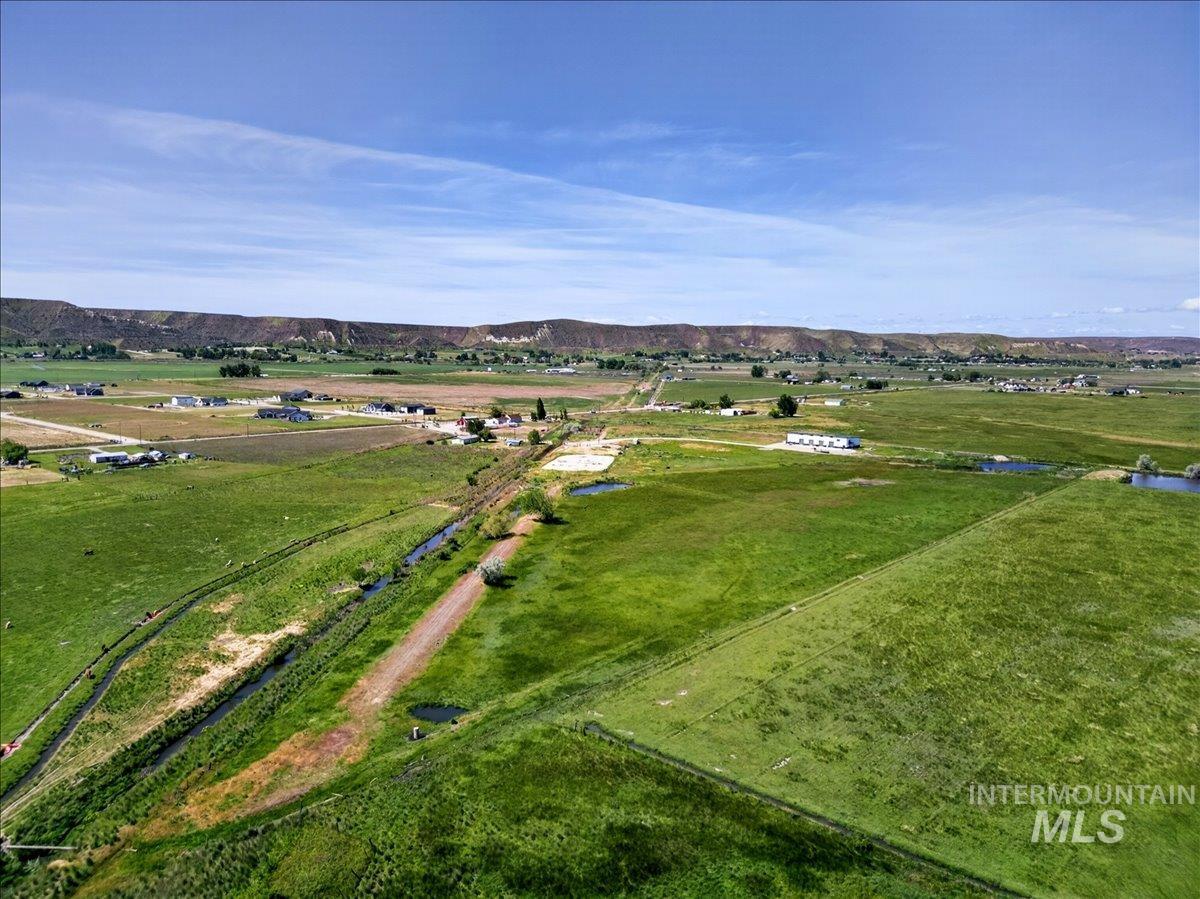 2588 West Sales Yard Road Emmett, ID 83617 - Photo 8 of 49 Expansive agricultural landscape featuring vast green fields and a distant mesa backdrop