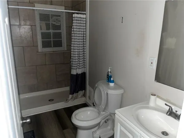 a bathroom with a sink toilet and shower