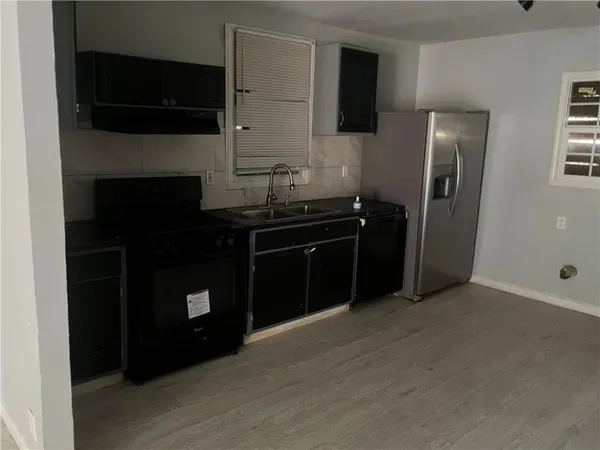 a kitchen with a sink and a refrigerator