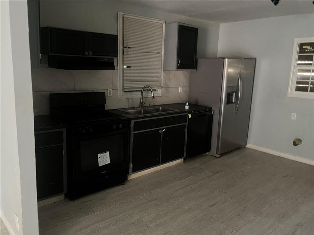 3363 Lake Valley Road Northwest Atlanta, GA 30331 - Photo 5 of 7 a kitchen with a sink and a refrigerator